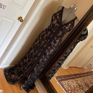 Gorgeous flower appliqué evening gown in black over tan liner.